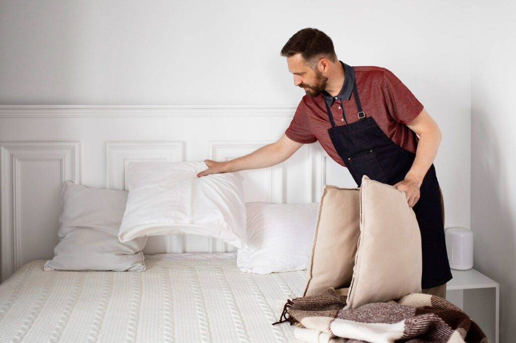 Man is making pillows on the bed