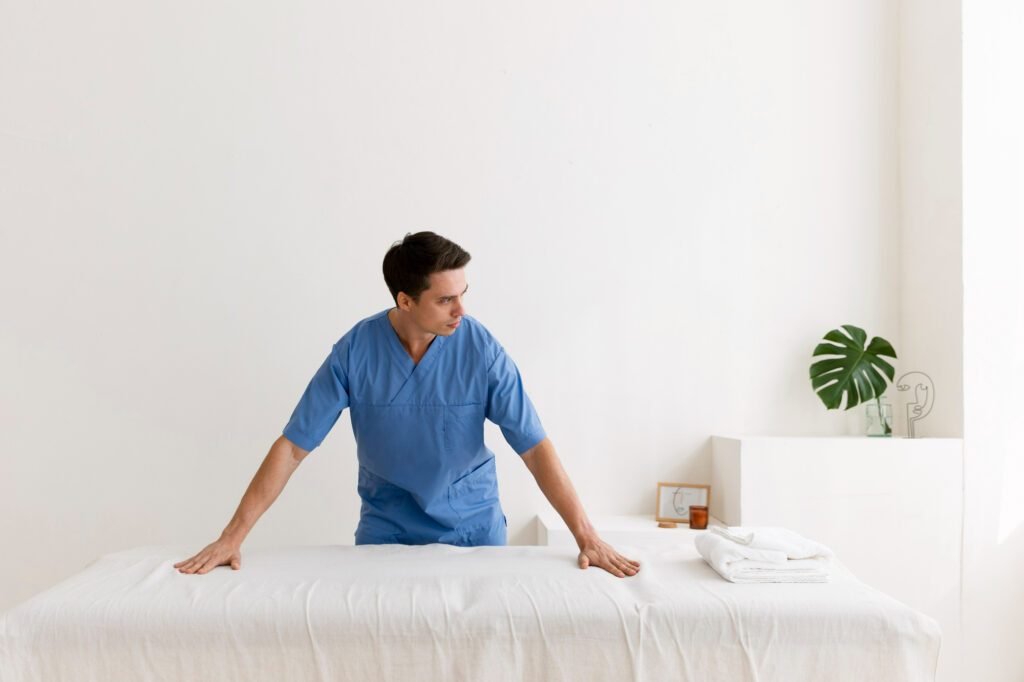 Man in blue shirt with hand on the mattress